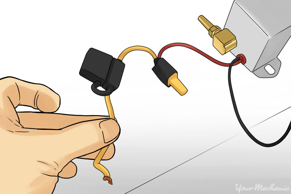 how to install offroad lights on your vehicle yourmechanic adviceperson holding inline fuse holder with blade fuse in it