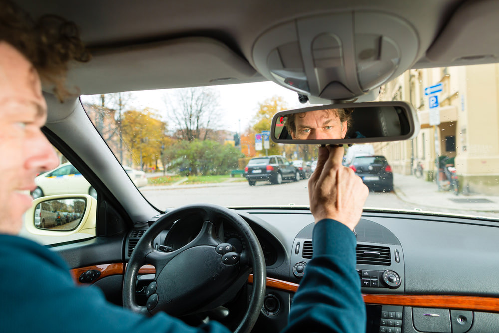 what does the switch on the bottom of the rearview mirror do